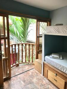 a bedroom with a bed and a balcony at Casa Mamá Waldy Hostel in Cartagena de Indias