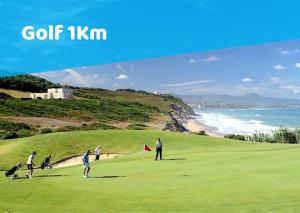 a group of people playing golf on a golf course near the ocean at Villa Vedetta - 4 pers - 200 m plage - Triangle d or Biarritz in Biarritz