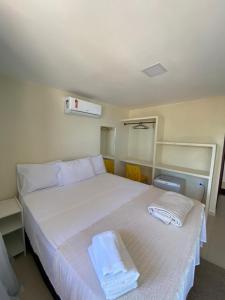 Un pat sau paturi într-o cameră la Pousada Grandmar, Maragogi