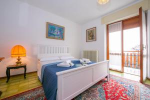 a bedroom with a bed and a table with a lamp at Villa La Verbanina Private Garden - Happy Rentals in Ghiffa +31 photos
