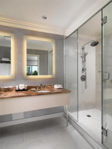 a bathroom with a sink and a shower at Hotel Grand Pacific in Victoria