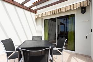 a black table and chairs on a patio at Costa Adeje Luxury Mango in Adeje