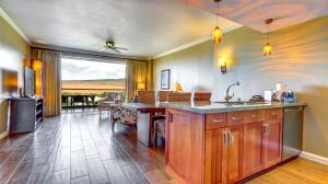 a kitchen with a sink and a counter top at Honua Kai - Konea 1024 in Lahaina