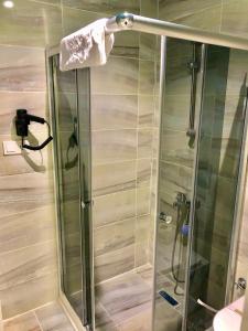 a shower with a glass door in a bathroom at Grand Atakum Boutıque Hotel in Mahmutlu