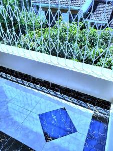 a white bench with blue tiles on it at Standard Gardens 1-2-3 bedrooms Apartment Kisumu in Kisumu