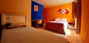 a hotel room with two beds and a desk at Canto da Lua in Lençóis