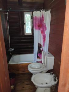 y baño con aseo, lavabo y bañera. en Cabaña de Troncos en la montaña en Mina Clavero