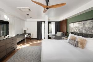 a bedroom with a large bed with a ceiling fan at Gravity Haus Vail in Vail