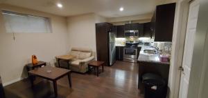 a small living room with a kitchen and a living room at Parson Creek in Fort McMurray