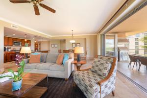 a living room with a couch and a table at Honua kai - Konea 301 Frontline with BBQ! in Kaanapali