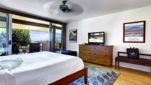 a bedroom with a bed and a television in it at Maui Eldorado - D206 in Lahaina +24 photos