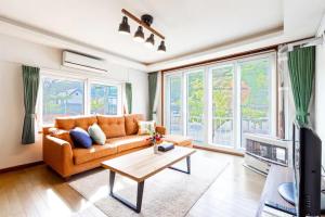 a living room with a couch and a table at THE SUNLIGHT in Sapporo