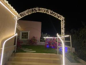 an archway with christmas lights in front of a house at Farm Al Medfek in Ras al Khaimah