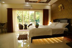 a bedroom with a large bed and a large window at Riverside Inn Homestay in Cochin