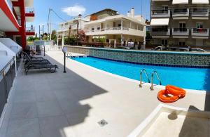 a swimming pool in front of a building at Princess Luxury Suite in Paralia Katerinis