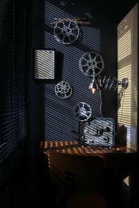 a dark room with a desk with wheels hanging on a wall at Hotel Auberge des Remparts in Laval