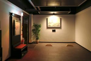 un couloir avec une salle d'attente avec une photo sur le mur dans l'établissement In-stone Motel, à Taipei