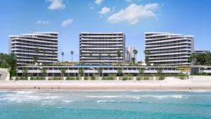 5* Apt, Best Location, Playa San Juan, heated pool في أليكانتي: مبنيان طويلان على الشاطئ مع المحيط