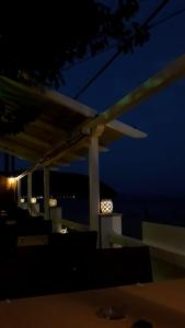 a lit up pergola at night with the sky at Ammos Studios and Apartments in Mikro