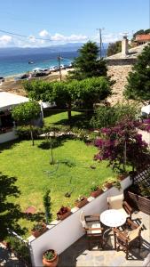 a view of a garden with a table and chairs at Ammos Studios and Apartments in Mikro