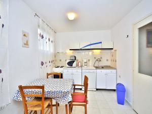 kuchnia ze stołem i krzesłami oraz stołem i stołem w obiekcie Apartments Miro 636 w Rovinj