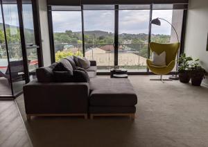 a living room with a couch and a chair at The Botanical 301 in Albury