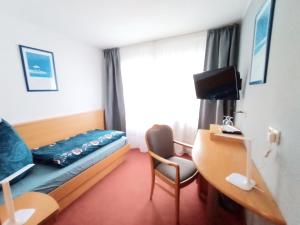 TV a/nebo společenská místnost v ubytování BodenSEE Gästehaus Tettnang ALBERGO