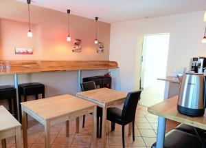 a restaurant with two tables and chairs and a counter at BodenSEE Gästehaus Tettnang ALBERGO in Tettnang