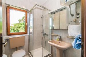 a bathroom with a shower and a sink at Apartments Pino Rabac in Rabac +39 photos