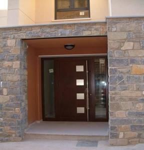 a entrance to a building with a brown door at Apartamento VUT manypi VU-HUESCA-21-024 in La Puebla de Castro