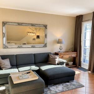 a living room with a couch and a large mirror at Luxus Ferienwohnung schöne Aussicht in Hahnenklee-Bockswiese