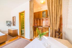 a kitchen with a table and a room with a sink at Apartments Antić 4255 in Selce