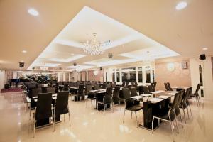 a banquet hall with tables and chairs and a chandelier at Ever Luck Hotel in Kaohsiung
