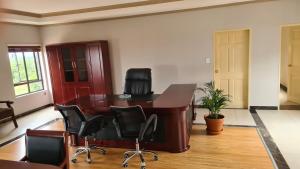 an office with a desk and chairs in a room at LilyPark Lodge in Rustenburg