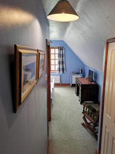an attic room with a hallway with a desk at The Compasses Inn in Fordingbridge