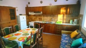 a kitchen with a table and a dining room at Apartment Vidas in Kampor