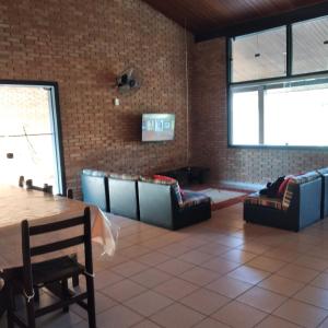 a dining room with couches and a table in a room at Casa na Praia do Lázaro em Ubatuba/SP in Ubatuba