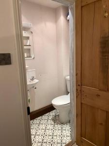 a bathroom with a toilet and a sink at Rock View Cottage, 2 bedrooms near Alton Towers in Alton