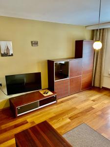 a living room with a large flat screen tv at Comfortable Stay in Siauliai in Šiauliai