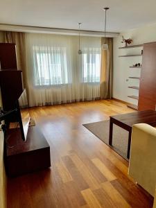 a living room with a couch and a table at Comfortable Stay in Siauliai in Šiauliai