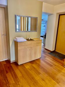 a room with a dresser and a mirror on the wall at Comfortable Stay in Siauliai in Šiauliai