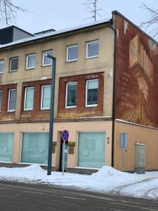 a building on the side of a street with a street light at Comfortable Stay in Siauliai in Šiauliai