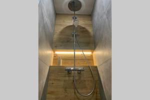 a shower in a bathroom with wooden floors at *** Le Refuge *** Logement standing Megève in Demi-Quartier +27 photos