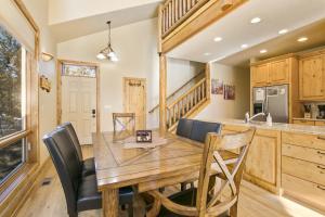 een keuken en eetkamer met een houten tafel en stoelen bij Tranquility On The River Four -- EV #6041 townhouse in Estes Park