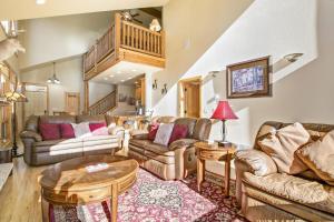 a living room with couches and a table at Tranquility On The River Four -- EV #6041 townhouse in Estes Park