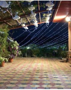 a room with lights hanging from a ceiling at استراحة المعمورة Al maamoura Retreat in Hatta
