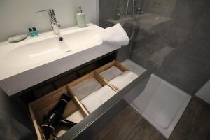 a bathroom with a sink and a mirror and a sink at Zeewende 18 in Zeebrugge