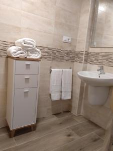 a bathroom with a sink and a toilet and towels at Alojamiento Lo Trabucador in El Poblenou del Delta +95 photos