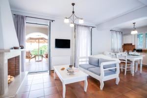 a living room with a couch and a table at Meganisi Villas in Spartokhórion