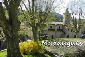 a house with a tree and a church at Cocon au pied de la sainte-baume in Mazaugues